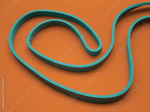 Green rubber resistance band curving on a vibrant orange textured background