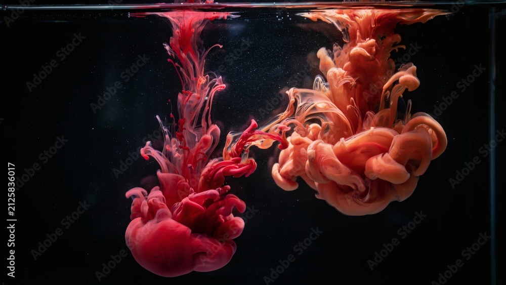 Obraz premium Abstract red and orange ink drops swirling underwater with streams swirling mixing mixing dark water vibrant red background diffusion creative