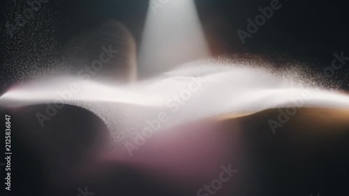 A mesmerizing abstract light explosion with floating dust particles in a dark atmosphere. 4k Video footage.