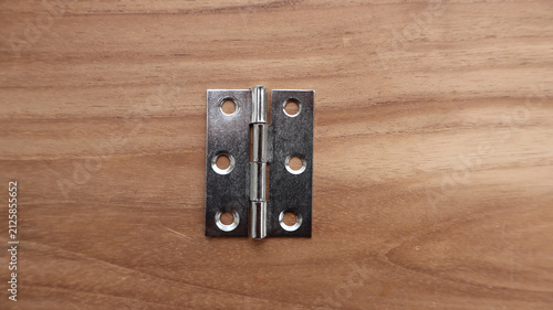 Single Steel Butt Door Hinge on Wooden Surface