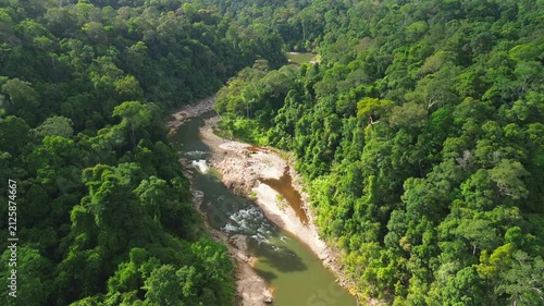 Drone flyover following Sungai Tembeling winding through primary tropical rainforest, Al-Sultan Abdullah Royal Tiger Reserve, Pahang, Malaysia, May 2026