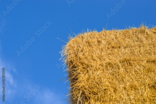 Photo of blue sky and straw bales