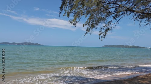 beach with soft  sand, crystal-clear blue sea, and a peaceful atmosphere under natural sunlight. 