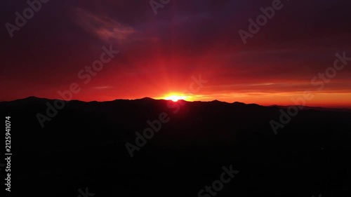 Dramatic Mountain Sunset with Fiery Sky and Sun Rays
