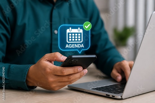 Business person using smartphone and laptop with agenda icon overlay for scheduling