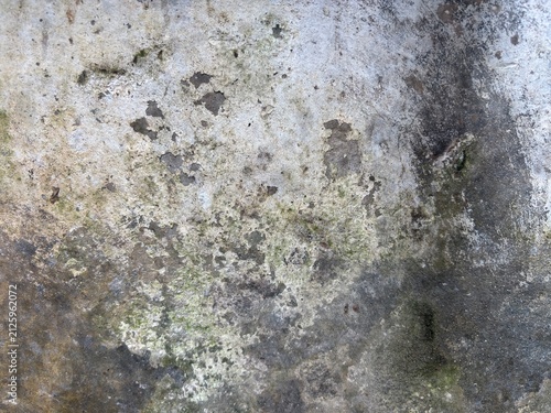 Close-up of weathered concrete wall with visible cracks and stains.