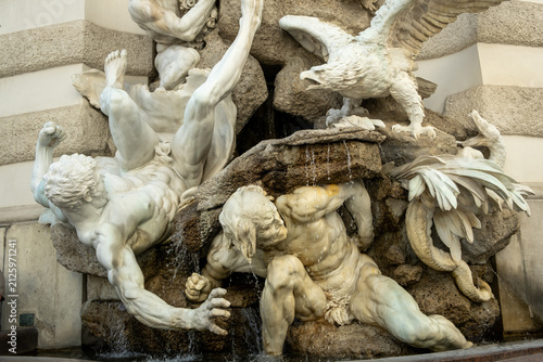 Close-up of monumental stone fountain statues at Michaelerplatz.