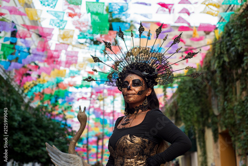 Woman With Day of the Dead Makeup Beneath Colorful Papel Picado Decorations