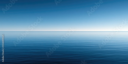 A tranquil ocean horizon with vast blue sky meeting calm water