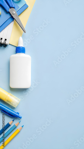 Top view of school and office stationery supplies with copy space on light blue background