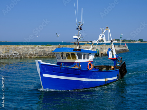 Closeup of blue fishing boat returning to port at Saint-Vaast-la-Hougue, a commune in the peninsula of Cotentin in the Manche department in Lower Normandy in north-western France