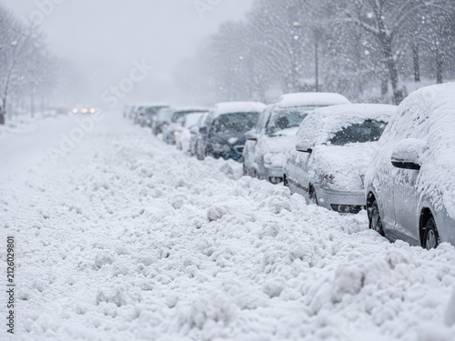 Snow car street winter blizzard covers parked vehicle along urban road