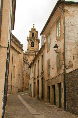 Historic Cobblestone Street Leading to Ancient Church Tower