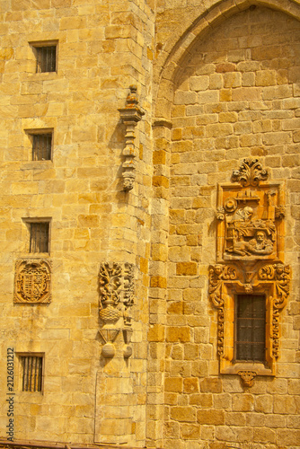 Ornate Baroque Stone Facade with Ancient Carvings and Barred Windows. Mondoñedo cathedral