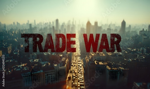 The words 'trade war' are emblazoned in large red letters over a sprawling cityscape with heavy traffic congestion below.