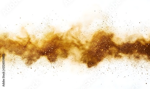 Golden sand particles and glitter explode outward in a controlled stream against a bright white backdrop.