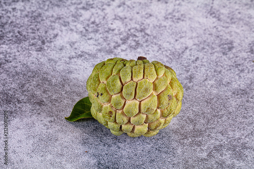 Cuadro en lienzo Fresh ripe custard apple or sugar apple with leaf on textured grey background