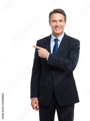 Smiling Businessman in Suit Pointing Finger at Copy Space