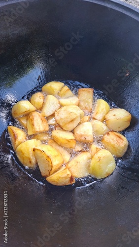 Quadro su tela Potatoes, meat, and onions cut into large chunks in a cauldron.