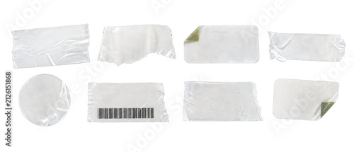 Assortment of clear plastic stickers and tape pieces with various shapes and textures, isolated on transparent background, modern design elements for layering.