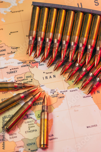 bullets standing over a world map as a conceptual metaphor for global geopolitical conflict war crisis between Ukraine, Russia, Iran, Israel, China, Taiwan, Japan, and USA in Strait of Hormuz