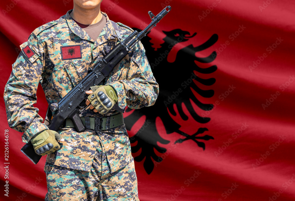 Obraz premium Albania flag with soldier holding assault rifle