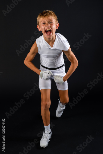 Young football player celebrating big play with excited victory shout