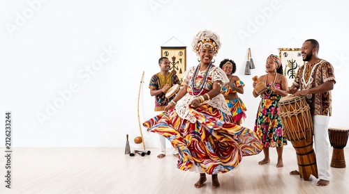 Group of people in traditional African attire dancing and playing instruments
