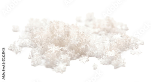 Close-up of delicate snowflakes scattered on a white background