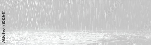 Heavy rain captured in motion as it falls onto a reflective water surface with splashes and droplets visible on transparent background