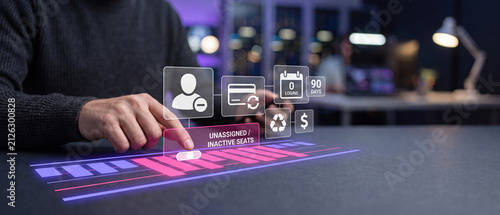 Businessman interacting with a holographic interface to manage unassigned and inactive software seats for cost optimization