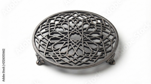 Antique cast iron trivet with openwork geometric star pattern, ornate feet, isolated on white background