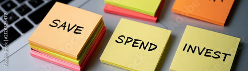 Save spend invest money budget finance planning concept note office desk sticker paper reminder message education literacy management strategy choice text handwriting business stack organization