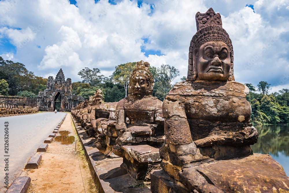 Fototapeta premium Ancient stone guardian statues lining the causeway at the South Gate of Angkor Thom in Siem Reap, Cambodia