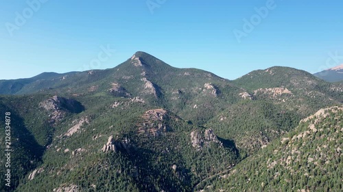 Moving aerial mountain views against clear blue sky