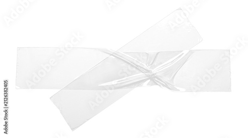 Fotografie Crossed translucent  wrinkled clear adhesive sticky tape strips on a transparent