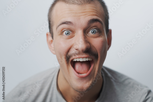 Quadro su tela Portrait of a happy young man with mustache smiling broadly