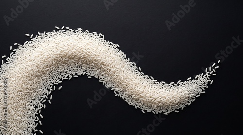 Uncooked white rice grains in a wave pattern. Raw cereal forming a flowing abstract shape.