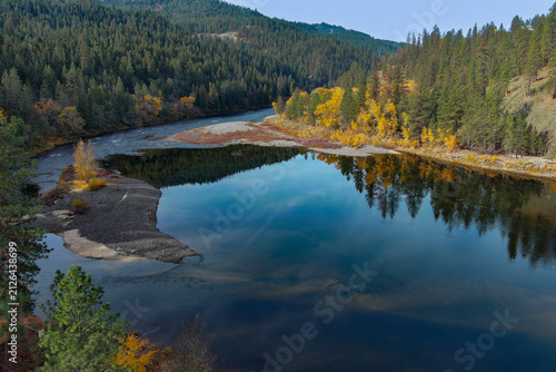 beautiful drone photo of the Clearwater River near Orofino ID reflecting the sky and fall foliage in rural mountain area