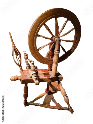 Traditional wooden spinning wheel with large circular wheel, treadle, and spindle used for twisting fibers into yarn on white isolated background