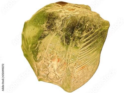 Large translucent yellow-green crystal with rough surface, internal striations, and natural mineral inclusions on white isolated background
