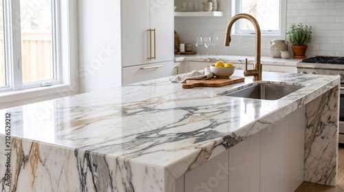 High angle view of polished Calacatta marble countertop surface with undermount sink and gold tap