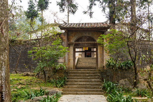 Traditional stone arched gateway leading up ancient stairs, Dinh thu Vua Meo, Vietnam