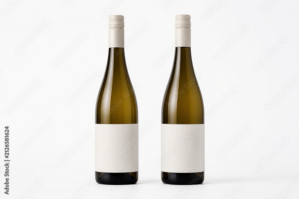 Obraz premium Two bottles of white wine are displayed against a plain white background.