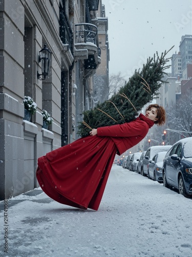 Joyful woman in a flowing red coat carrying a Christmas tree through a snowy city street, capturing festive spirit, winter fashion and magical holiday storytelling.