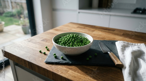 Fresh Green Peas In A Bowl Ready For Preparation On A Kitchen Countertop