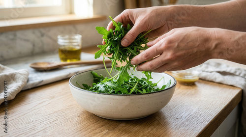 Fresh Greens Being Added To A Salad Bowl