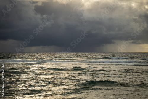 Canvastavla Dramatic sunrise over the ocean with stormy clouds on the horizon