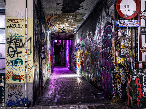 Colorful Graffiti-Covered Alleyway Illuminated with Purple Lights at Night in Ghent, Belgium