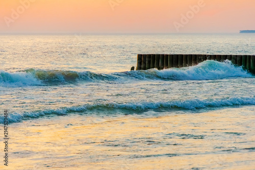 Sunset twilight over sea wooden breakwater